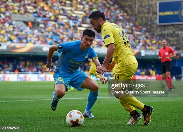 Jaume Costa of Villarreal competes for the ball with Abzal Beysebekov of Astana during the UEFA Europa League group A match between Villarreal CF and...