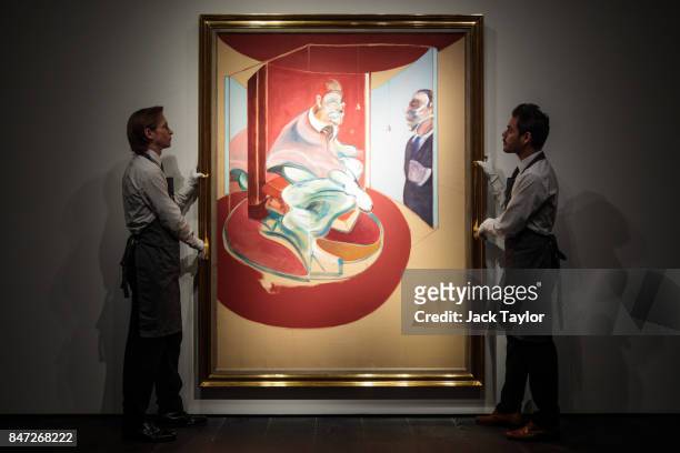Christie's employees pose with Study of a Red Pope, 1962. 2nd Version 1971 by Francis Bacon at Christie's on September 15, 2017 in London, England....