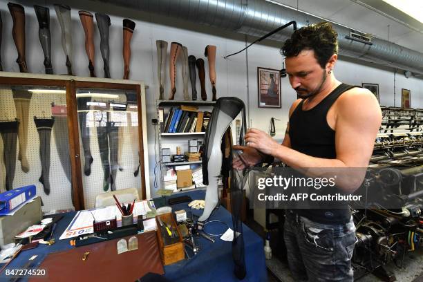 Employee works in the factory of silk stockings and underwear manufacture company Arsoie Cervin on September 7, 2017 in Sumene, southern France. /...