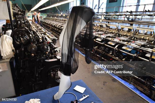 Silk stockings are pictured by weaving looms in the factory of silk stockings and underwear manufacture company Arsoie Cervin on September 7, 2017 in...