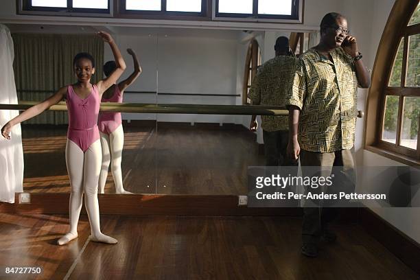 Herman Chinery-Hesse, the founder and CEO of BSL and Soft Tribe talks on his mobile phone while attending his daughters dance residual on June 12,...