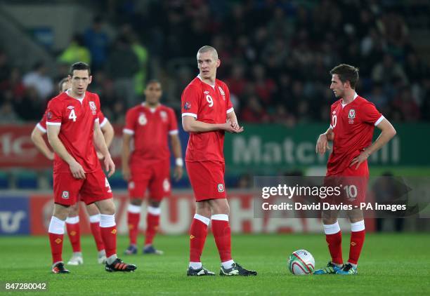 Wales' Steve Morison and Joe Allen prepare to kick-off after going a goal down