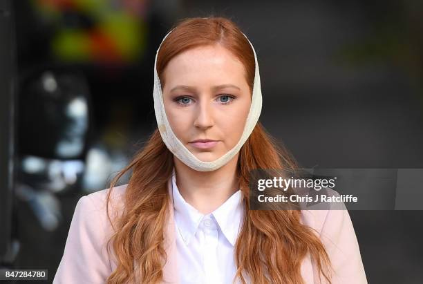 An injured woman makes her way from the scene at Parsons Green Underground Station on September 15, 2017 in London, England. Several people have been...
