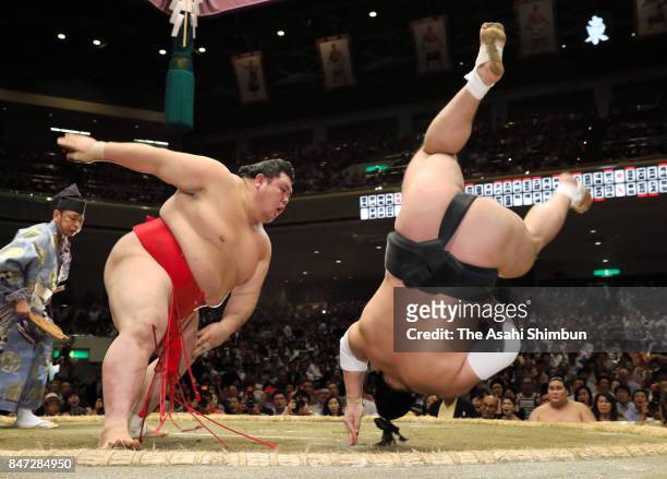 Onosho throws Mongolian yokozuna Harumafuji to win during day five of the Grand Sumo Autumn Tournament at Ryogoku Kokugikan on September 14, 2017 in...