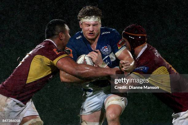 Blake Gibson of Auckland is tackled by Bill Fukofuka and Mike McKee of Southland during the round five Mitre 10 match between Southland and Auckland...