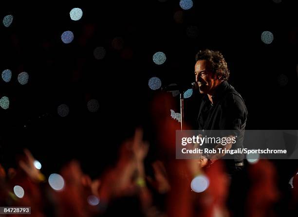 Musician Bruce Springsteen and the E Street Band perform at the Bridgestone halftime show during Super Bowl XLIII between the Arizona Cardinals and...