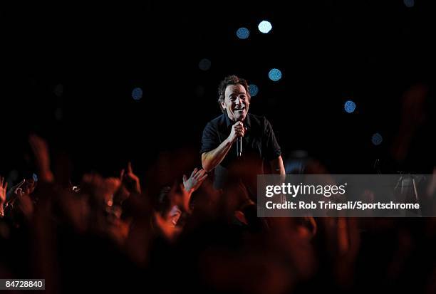 Musician Bruce Springsteen and the E Street Band perform at the Bridgestone halftime show during Super Bowl XLIII between the Arizona Cardinals and...