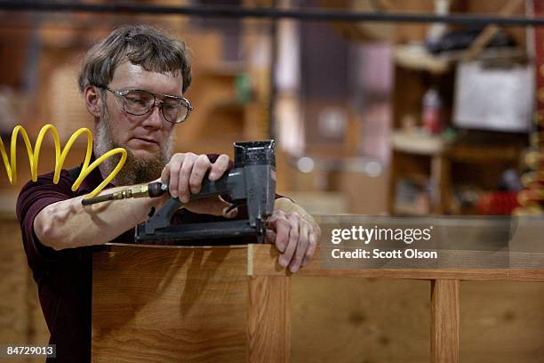 Worker at Jayco, Inc., the country's third largest maker of recreational vehicles, builds cabinetry for an RV February 10, 2009 in Middlebury,...