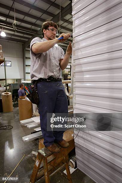 Worker at Jayco, Inc., the country's third largest maker of recreational vehicles, helps to construct Jay Flight travel trailers February 10, 2009 in...