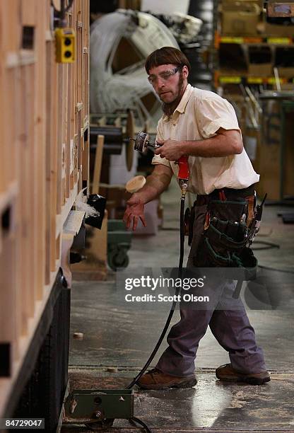 Worker at Jayco, Inc., the country's third largest maker of recreational vehicles, helps to construct Jay Flight travel trailers February 10, 2009 in...