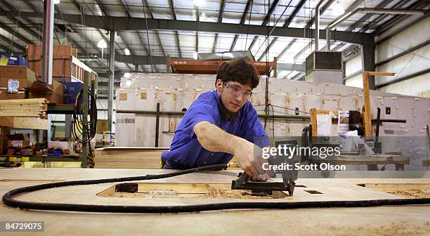 Worker at Jayco, Inc., the country's third largest maker of recreational vehicles, builds wall panels for a Jay Flight travel trailer February 10,...