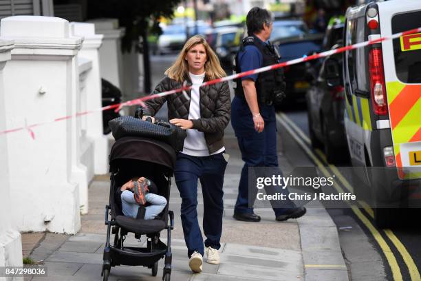 Woman with her young child leave the police cordon at Parsons Green Underground Station on September 15, 2017 in London, England. Several people have...