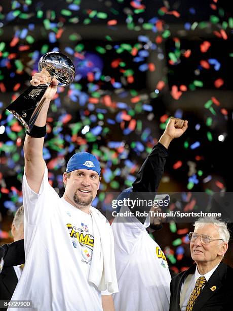 Quarterback Ben Roethlisberger of the Pittsburgh Steelers holds up the Vince Lombardi Trophy as Mike Tomlin and Dan Rooney look on after defeating...