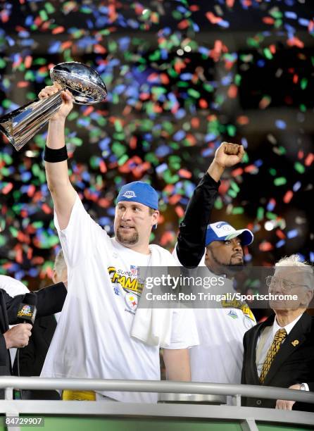 Quarterback Ben Roethlisberger of the Pittsburgh Steelers holds up the Vince Lombardi Trophy as Mike Tomlin and Dan Rooney look on after defeating...