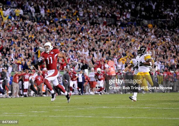 Wide receiver Larry Fitzgerald of the Arizona Cardinals runs for a touchdown in the fourth quarter against the Pittsburgh Steelers during Super Bowl...