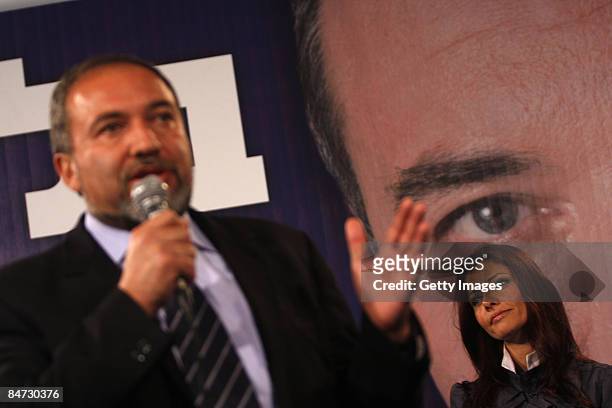 Orly Levi listens to Avigdor Lieberman, leader of Yisrael Beiteinu party, speak after hearing exit poll results at party headquarters February 10,...