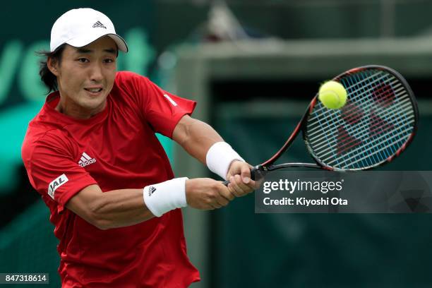 Go Soeda of Japan plays a backhand in his singles match against Thiago Monteiro of Brazil during day one of the Davis Cup World Group Play-off...