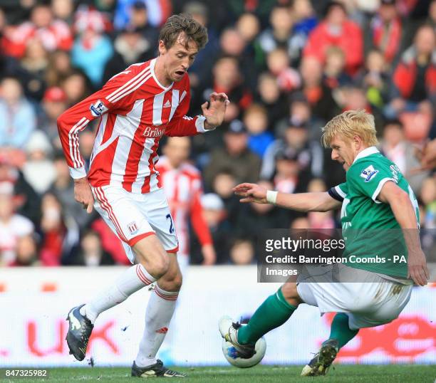 Stoke City's Peter Crouch and Norwich City's Zak Whitbread battle for the ball during the Barclays Premier League match at the Britannia Stadium,...
