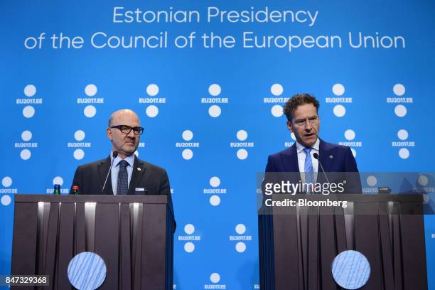 Pierre Moscovici, economic commissioner for the European Union , left, looks on as Jeroen Dijsselbloem, Dutch finance minister and head of the group...