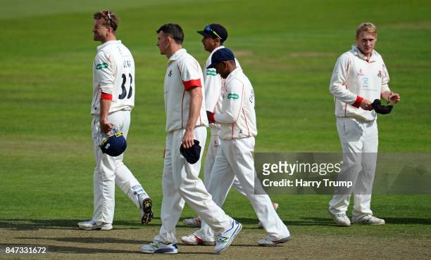 Members of the Lancashire side cut dejected figures after their sides defeat during Day Four of the Specsavers County Championship Division One match...