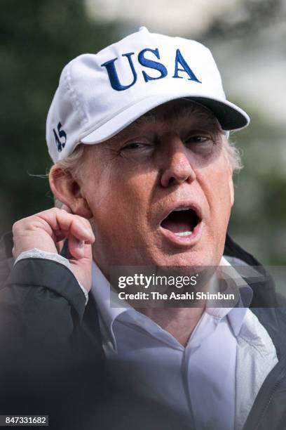 President Donald Trump listens to a question from a member of the media after he returned to the White House from Florida on September 14, 2017 in...