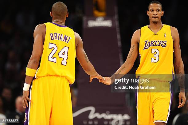 Kobe Bryant and Trevor Ariza of the Los Angeles Lakers slap hands during a game against the Oklahoma City Thunder at Staples Center on February 10,...