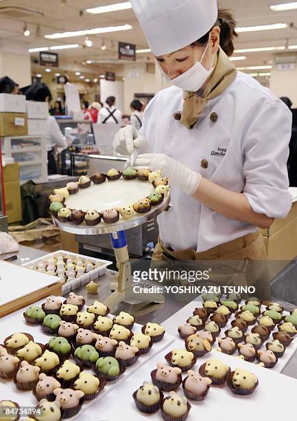 Japan's sweet shop Goncharoff chocolatier puts the finishing touches to animal-shaped chocolates at Takashimaya department store's large chocolate...