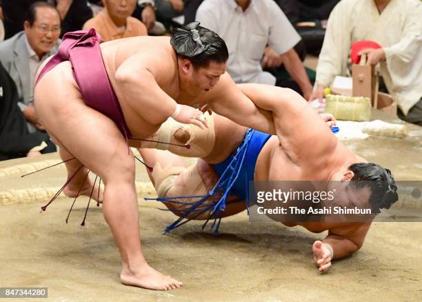 Sekiwake Mitakeumi throws Kotoshogiku to win during day six of the Grand Sumo Autumn Tournament at Ryogoku Kokugikan on September 15, 2017 in Tokyo,...