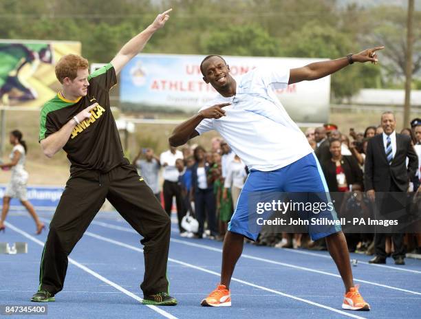 Prince Harry with Olympic sprint champion Usain Bolt doing his signature sign after a short sprint, at the University of the West Indies, in Jamaica...