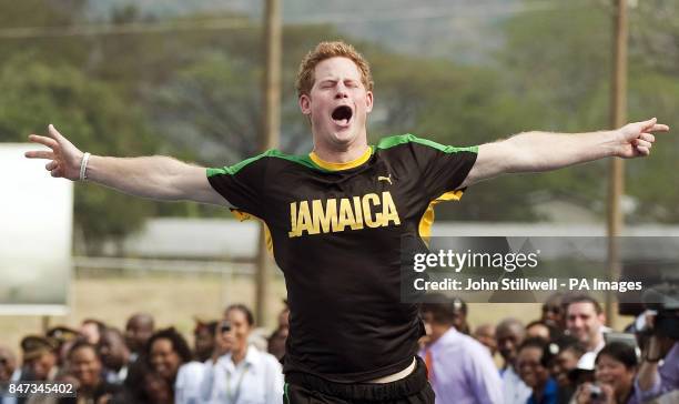 Prince Harry looks pleased after beating Olympic sprint champion Usain Bolt to a short sprint, at the University of the West Indies, in Jamaica where...