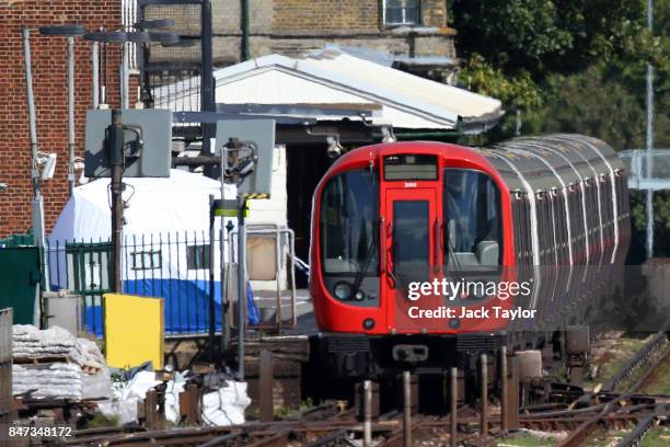 Forensic tent is seen next to the stopped tube train at Parsons Green Underground Station on September 15, 2017 in London, England. Several people...