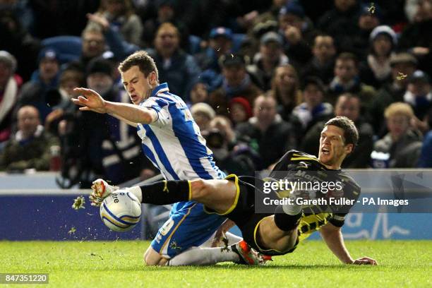 Brighton's Ashley Barnes is challenged by Cardiff's Mark Hudson during the npower Championship match at the AMEX Stadium, Brighton.