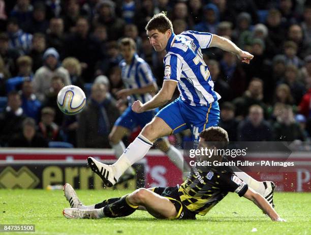 Brighton's Sam Vokes is challenged by Cardiff's Mark Hudson during the npower Championship match at the AMEX Stadium, Brighton.