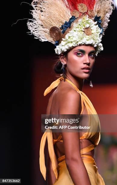 Model presents a creation of Francis Montesinos' Spring/Summer 2018 collection during the Madrid Fashion Week in Madrid on September 15, 2017. / AFP...