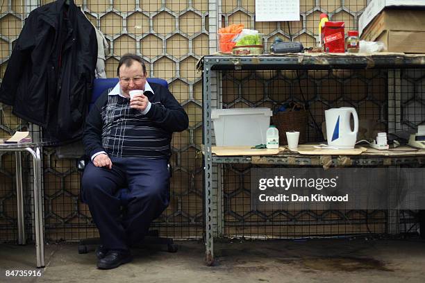 Market vendor takes a break from his stall in New Covent Garden Flower Market on February 11, 2009 in London, England. New Covent Garden Flower...