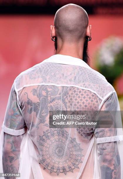 Model presents a creation of Francis Montesinos' Spring/Summer 2018 collection during the Madrid Fashion Week in Madrid on September 15, 2017. / AFP...