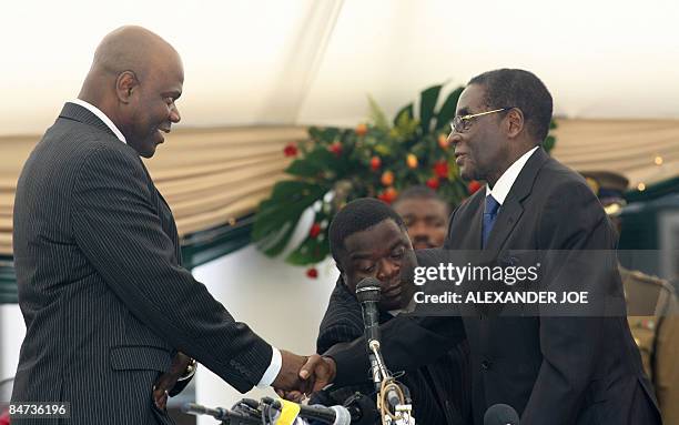 Zimbabwean President Robert Mugabe congratulates new Deputy Prime Arthur Mutambara of the opposition Movement for Democratic Change after swearing...