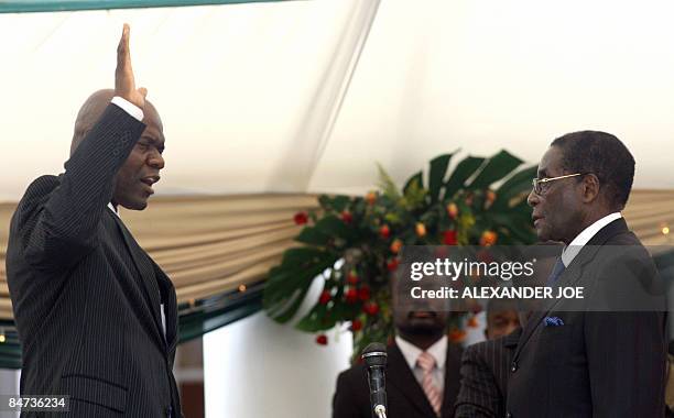 Zimbabwean President Robert Mugabe swears in new Deputy Prime Arthur Mutambara of the opposition Movement for Democratic Change at the State House in...