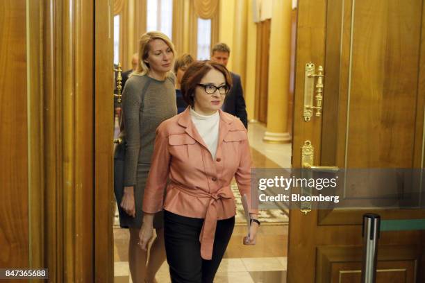 Elvira Nabiullina, Russia's central bank governor, center, arrives for a news conference to announce interest rates in Moscow, Russia, on Friday,...