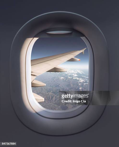 view from a airplane - airplane window stockfoto's en -beelden