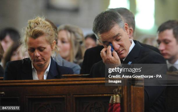 Darren Rathband, twin brother of Pc David Rathband, wipes away tears as he sits alongside his fiancee Angie Stephenson during a memorial service at...