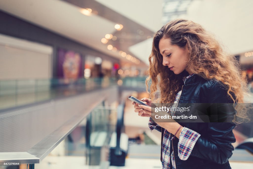 Woman in the shopping mall texting