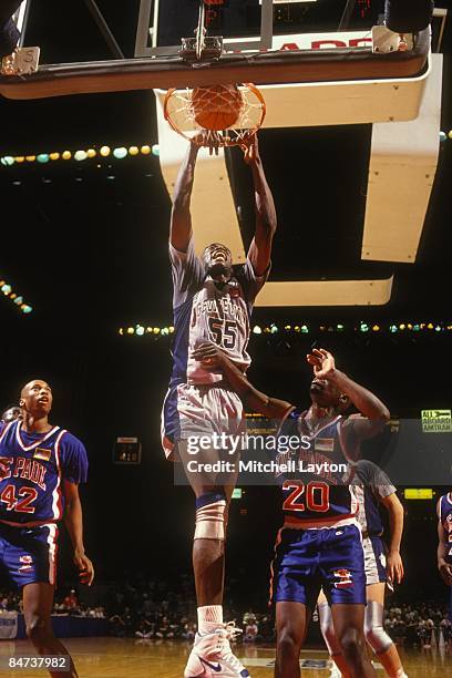 Dikembe Mutombo of the Georgetown Hoyas dunks during a college basketball game against the DePaul Blue Demons on December 15, 1991 at Capitol Centre...
