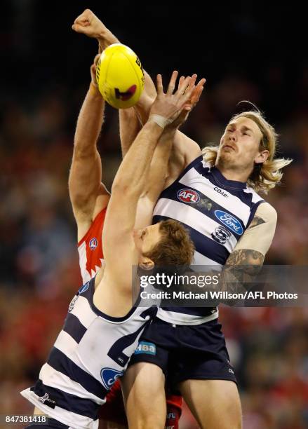 Tom Stewart of the Cats and Lachie Henderson of the Cats compete for the ball against Luke Parker of the Swans during the 2017 AFL Second Semi Final...
