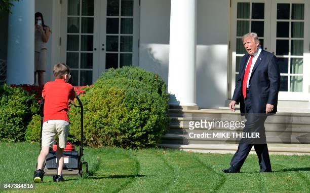 President Donald Trump watches Frank Giaccio of Falls Church, Virginia, as he mows the lawn in the Rose Garden of the White House on September 15 in...