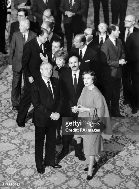 Queen Elizabeth II and the Duke of Edinburgh accompany Soviet President Mikhail Gorbachev and his wife Raisa in the Waterloo Chamber at Windsor...