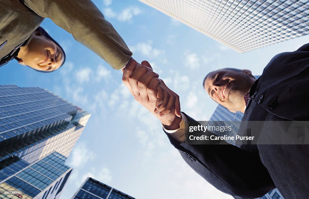 Eurasian woman shakes hands with european man