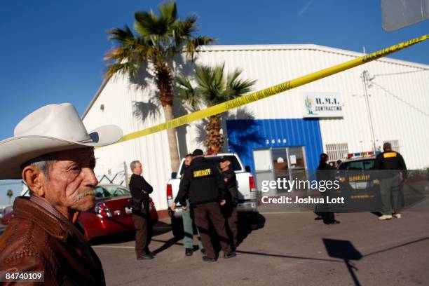 Abel Arana looks on after his son was arrested as Maricopa County Sheriffs conducted an immigration raid at HMI Contracting February 11, 2009 in...