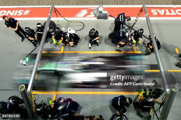 Mercedes's British driver Lewis Hamilton drives out of the pit-lane during the second practice session of the Formula One Singapore Grand Prix night...