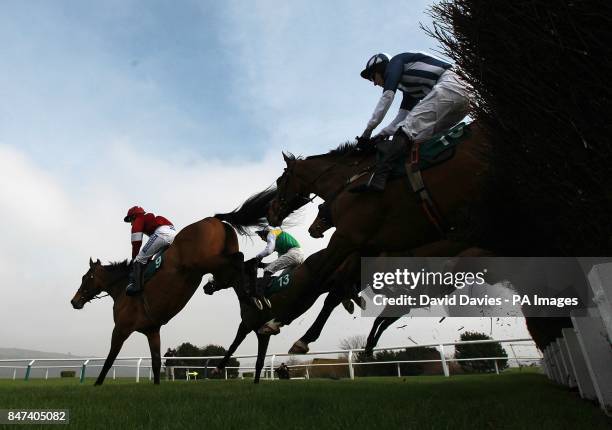 Teaforthree ridden by J T McNamara clears a fence behind Four Commanders ridden by Nina Carberry during the Diamond Jubilee National Hunt Chase on...